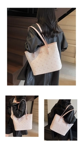 Detail shot of a large light pink tote bag with animal silhouette prints and slim straps