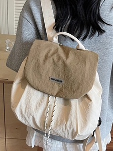 Fashionable color-block backpack in beige and tan nylon with drawstring and flap closure