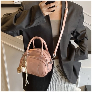 Pink Boston bag detail featuring baseball stitching texture and cute ball charm