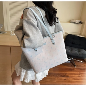 Close-up of the large capacity printed tote bag with blue deer pattern and leather straps