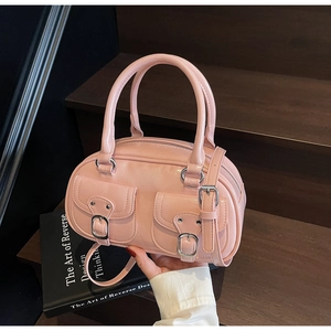 Pink Boston bag detail showing glossy PU leather, double front pockets, and silver hardware