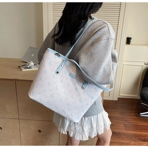 Close-up of animal print pattern and light blue leather details on large tote bag