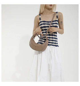 Détail du sac bandoulière en cuir grainé marron avec surpiqûres géométriques