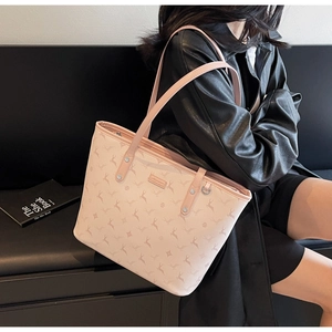 Close-up of pink printed tote bag featuring zipper closure and stylish animal pattern