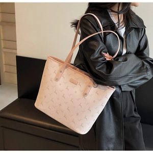 Close-up of pink deer print tote bag showing leather texture and silver metal rivets