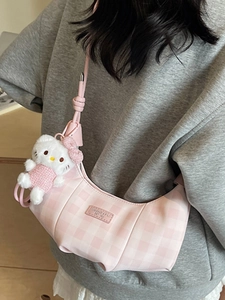 Pink and white checkered crescent shoulder bag with a plush doll charm for women