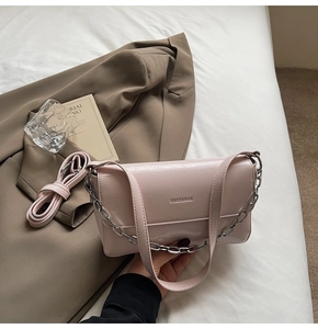 Pink baguette bag with silver chunky chain strap and detachable shoulder strap detail