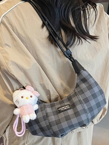 Checkered dumpling bag for women with black grey pattern and plush doll charm