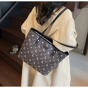Detail view of large capacity tote bag with star and animal print on model in beige coat