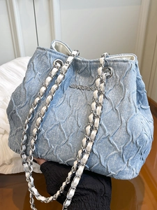 Light blue denim chain bag with quilted pleats and silver metallic branding logo
