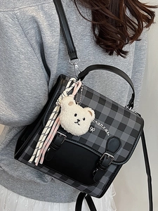 Classic black and gray plaid mini backpack with plush bear charm and striped ribbon