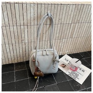 Detail view of light grey tote bag with double zippers and long shoulder straps