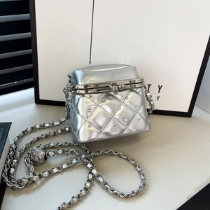 Close-up of silver quilted mini bag with rhinestone accents and metal clasp detail