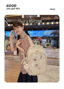 Detail of cream canvas backpack with transparent pocket and cute plush bear accessory