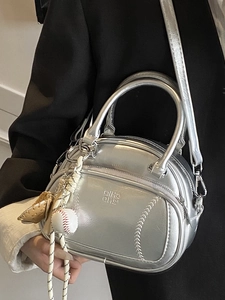 Metallic silver pillow bag with baseball stitch detail and mini ball charm for women