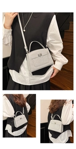 Detail view of silver sequin handbag with metallic turn-lock and adjustable shoulder strap