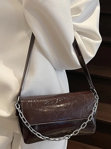Chic dark brown patent leather baguette bag with chunky silver chain shoulder strap