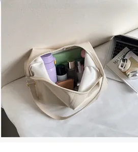 Detail showing the large interior capacity of this cream minimalist tote bag for daily commute