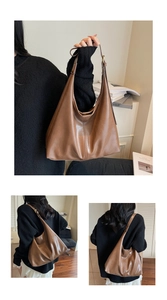 Detail view of large capacity dark brown soft leather bucket bag with hobo tote style