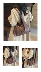 Detail view of large brown shoulder bucket bag showing shiny leather texture and gold buckle