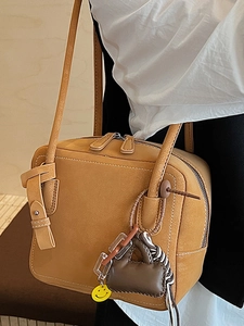 Minimalist tan tote bag for women with dual shoulder straps and a yellow smiley charm