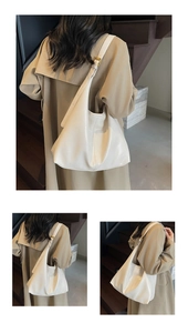Detail of a creamy white matte leather hobo bag with adjustable gold buckle strap