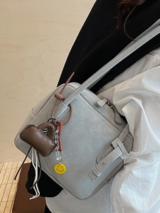 Minimalist light gray square tote bag for women with leather strap and smiley pendant