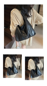 Detail of black tote bag with smooth leather finish and adjustable golden metal buckle
