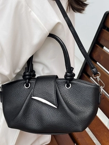 Chic black lychee leather handbag with curved design and stylish silver metal buckle