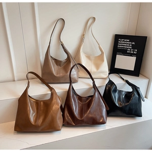 Multiple stylish leather hobo bags in five colors displayed on white geometric steps