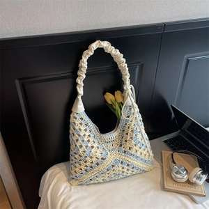 Handcrafted woven tote bag with light blue floral patterns and pleated leather handle