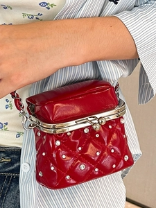 Red quilted crossbody bag with rhinestone accents and silver chain strap for women