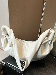 Minimalist white patent leather hobo bag with slouchy dumpling shape and silver zipper