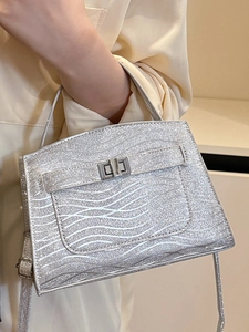 Silver glitter handbag with wavy texture and metallic clasp for stylish urban women