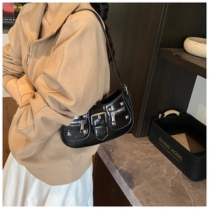 Detailed side view of black punk style underarm bag featuring silver rivets and zippers