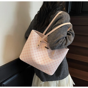 Borsa tote rosa monogram con cinturini in pelle indossata da modella su una scala interna