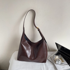 Detailed view of dark brown large hobo bag with adjustable strap and smooth matte finish