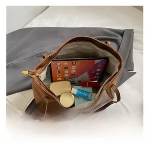 Detail view of large capacity tote bag interior showing ample space for tablet and makeup