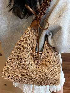 Straw tote bag with hollow woven patterns and brown faux leather ruffled handle