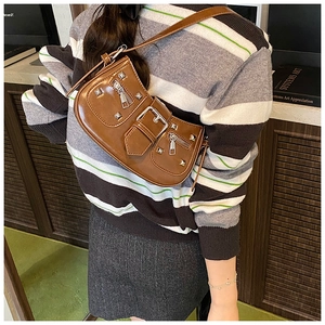 Detail showing Y2K brown shoulder bag with silver rivets and multiple zipper pockets