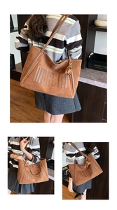 Detail of MORCHI embossed lettering on brown large capacity suede tote bag with charm