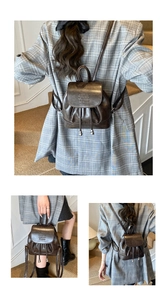 Detail of dark brown mini PU leather backpack with drawstring closure and flap engraving