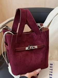 Chic burgundy suede bucket bag with drawstring interior and silver metal turn-lock buckle