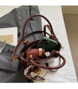 Dettaglio dell'interno capiente di una borsa in pelle cerata marrone scuro e scomparti