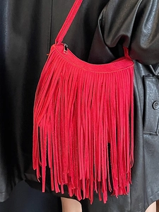 Fashionable red suede shoulder bag with long fringe tassels and slim strap for women