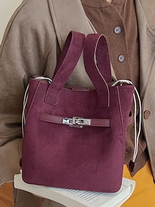 Fashionable burgundy suede bucket bag with silver turn-lock and large capacity