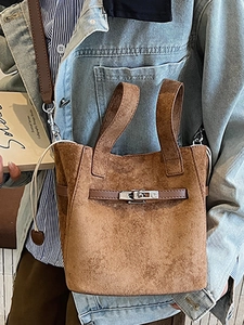 Vintage dark brown bucket bag with metallic lock closure and crossbody shoulder strap