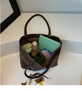 Detail view of large dark brown tote bag showing spacious interior and storage capacity