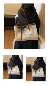 Détail de ce grand sac cabas en toile avec lanières en cuir et logo Paris élégant