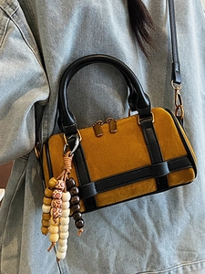Ginger yellow suede Boston bag with black leather trim and beaded tassel charm